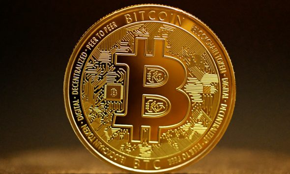 A shiny gold Bitcoin coin with the distinctive Bitcoin symbol, representing the seized cryptocurrency at the centre of the legal battle