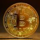 A shiny gold Bitcoin coin with the distinctive Bitcoin symbol, representing the seized cryptocurrency at the centre of the legal battle