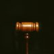 Wooden gavel on dark background representing UK court decision