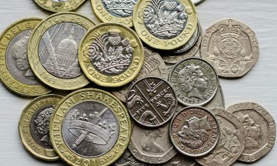 British pound coins representing UK banking restrictions on cryptocurrency transfers