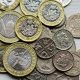 British pound coins representing UK banking restrictions on cryptocurrency transfers