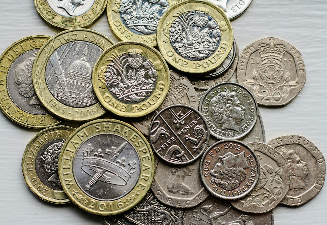 British pound coins representing UK banking restrictions on cryptocurrency transfers