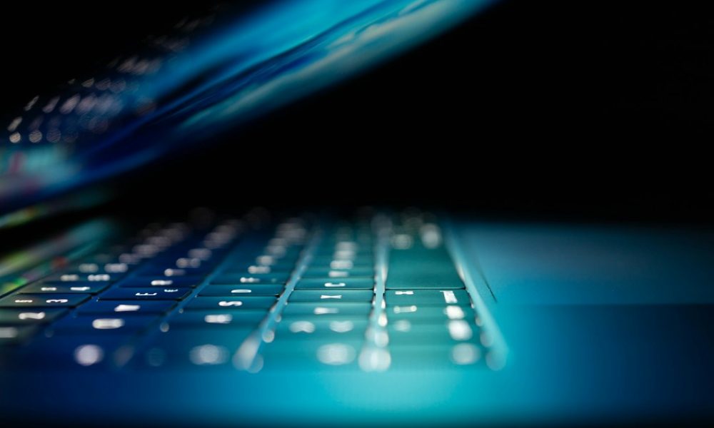 Close-up of laptop computer showing digital network data