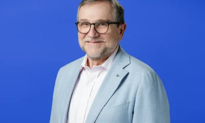 smiling portrait of a middle aged white man in a suit jacket