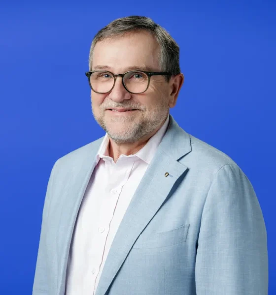 smiling portrait of a middle aged white man in a suit jacket