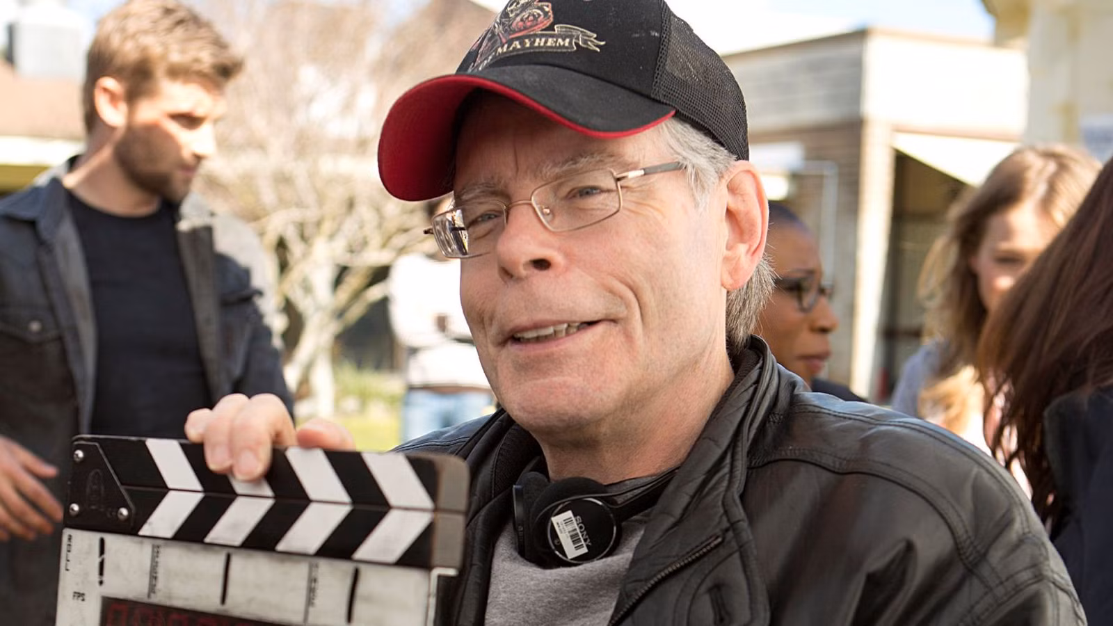 Stephen King on the set of Under the Dome smiling.