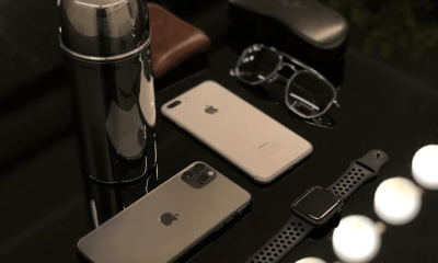Two iPhones with duo cases next to a coffee