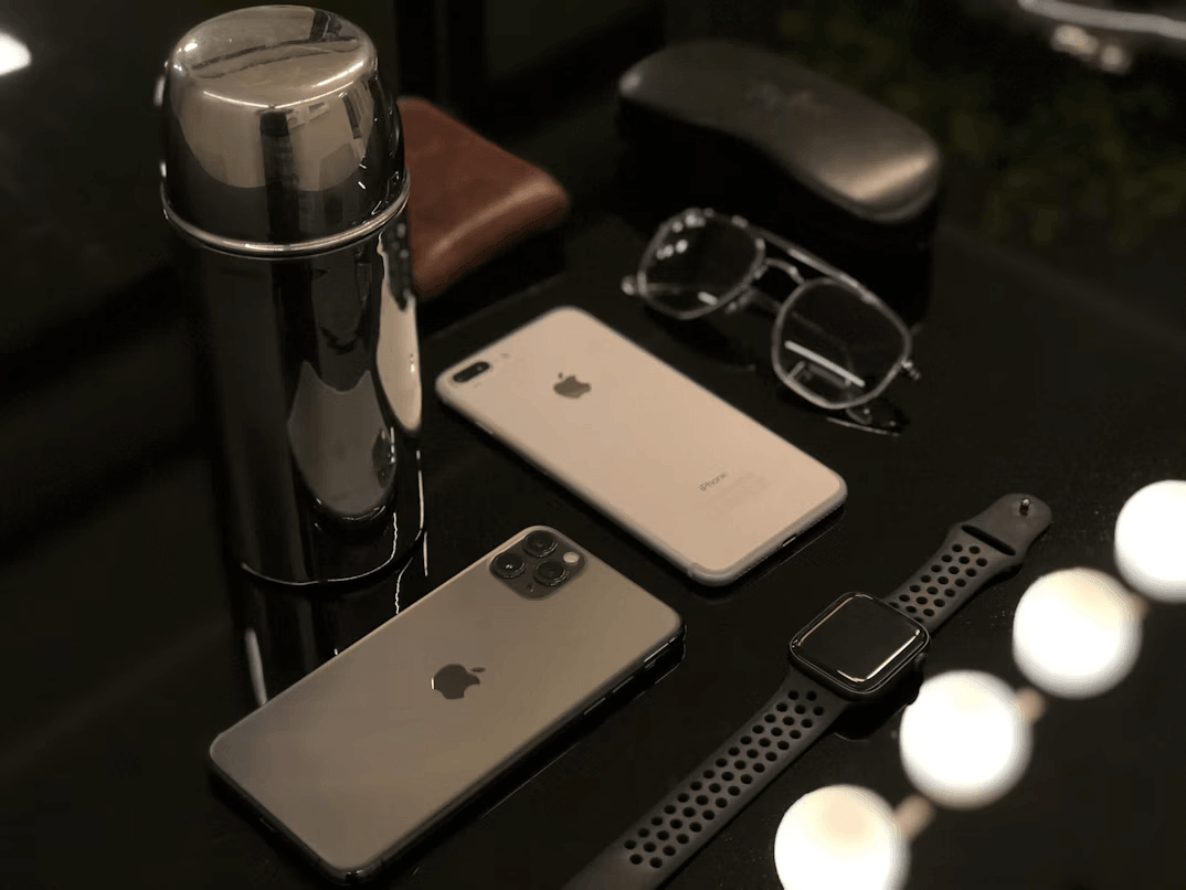 Two iPhones with duo cases next to a coffee
